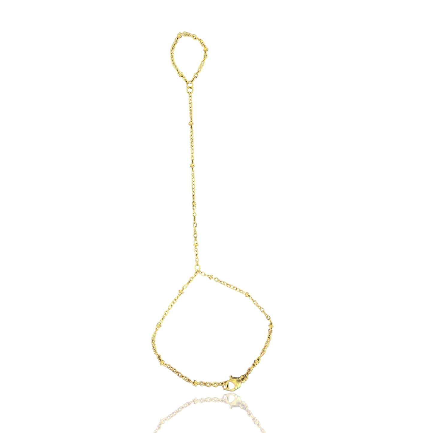 A gold hand chain bracelet laid out on a white surface, featuring a small ring at the top and a longer chain that drapes down into a bracelet. Stainless steel hand chain.